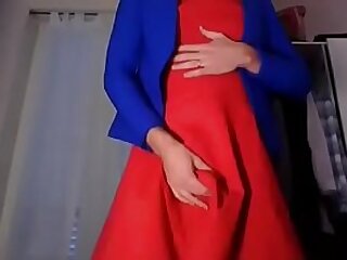 Young amateur cross dresser teasing and touching in a sexy red dress and cute blue blazer back from the office